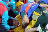 Wallabies centre Anthony Faingaa is fitted with a neck brace after being hit the head with a stray knee.