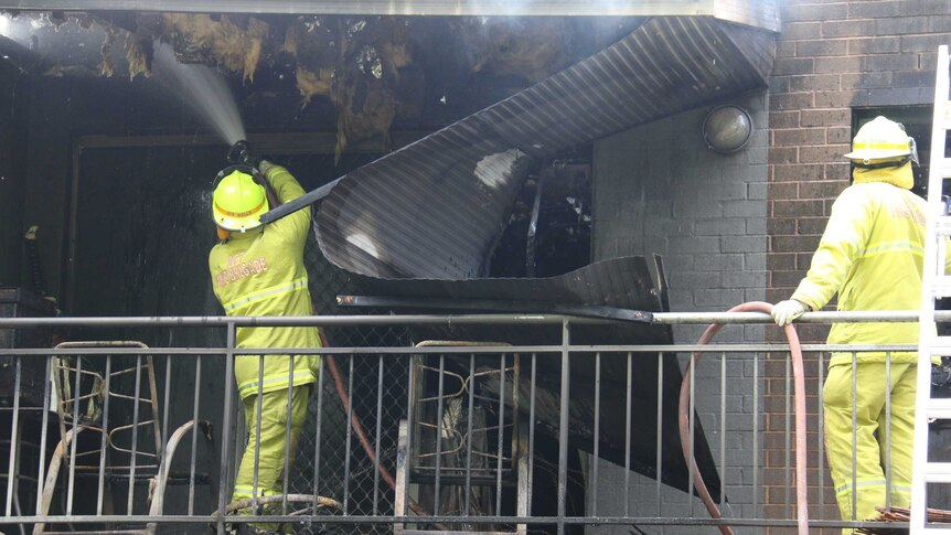 Firefighters hose down the Narrabundah apartment.