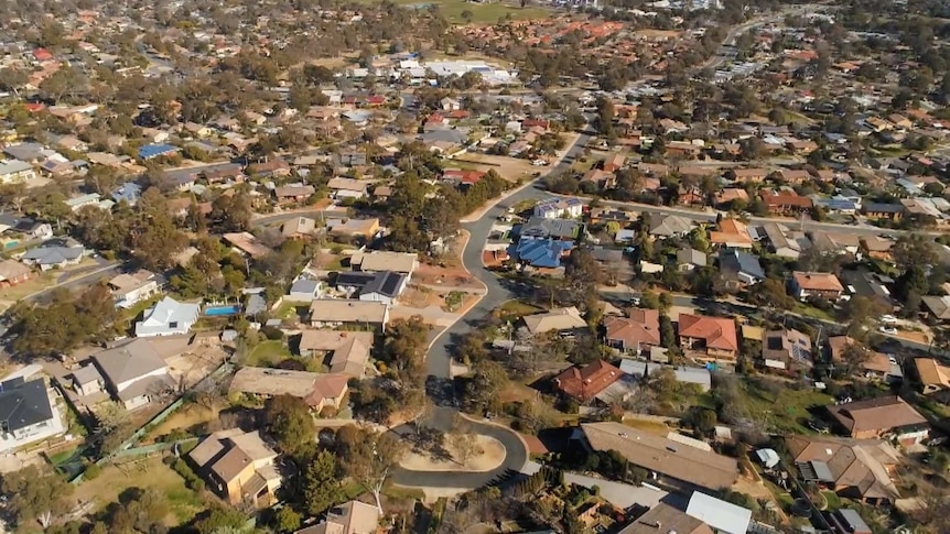 An aerial view of a suburb with standalone houses.