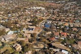 An aerial view of a suburb with standalone houses.