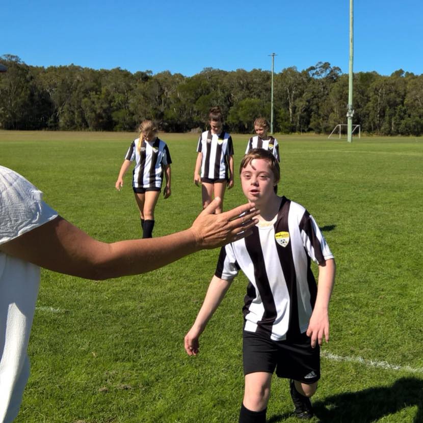 Marc Reichler-Stillhard high fives coach while leaving the football field