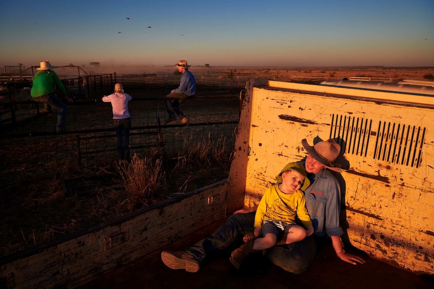 Rosie Jackson sits with two-year-old Jim in the back of a ute