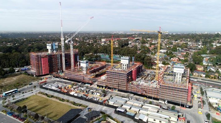 An aerial view of a large construction site covered in scaffolding.