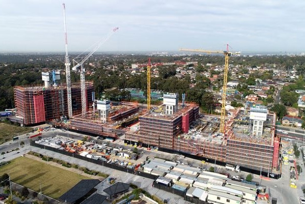 An aerial view of a large construction site covered in scaffolding.