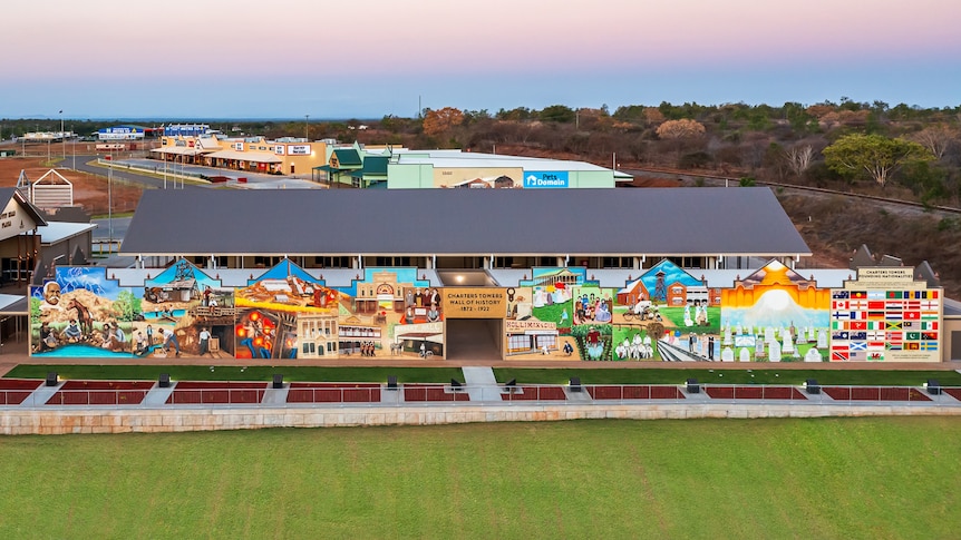 An aerial shot of a large colourful mural on the side of a building