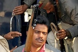 Surinder Koli (facing) is escorted by police to court