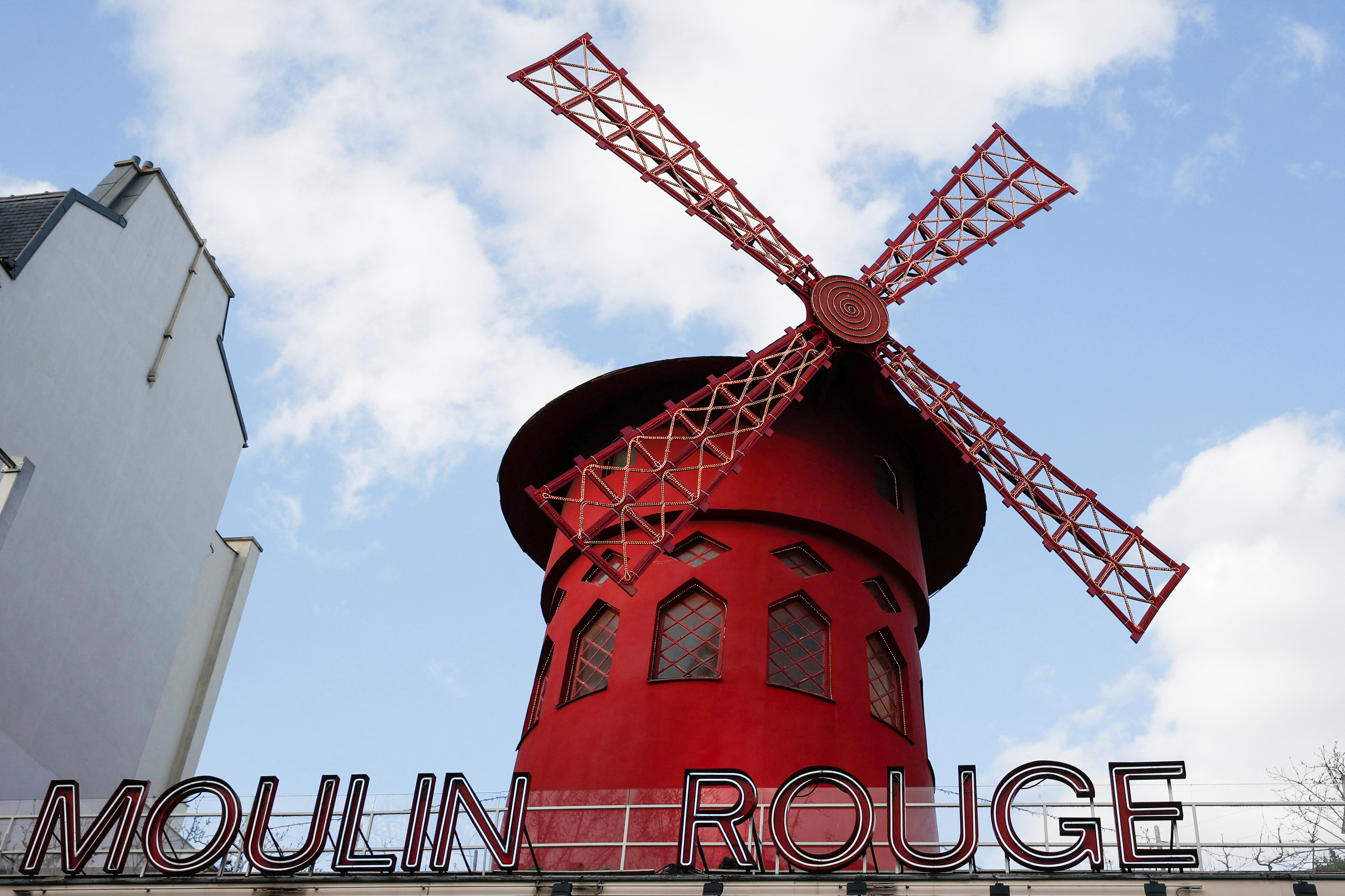 The Moulin Rouge sign and a red windmill above it.
