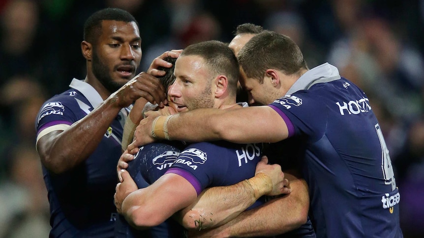 Storm players celebrates a try scored by Cooper Cronk