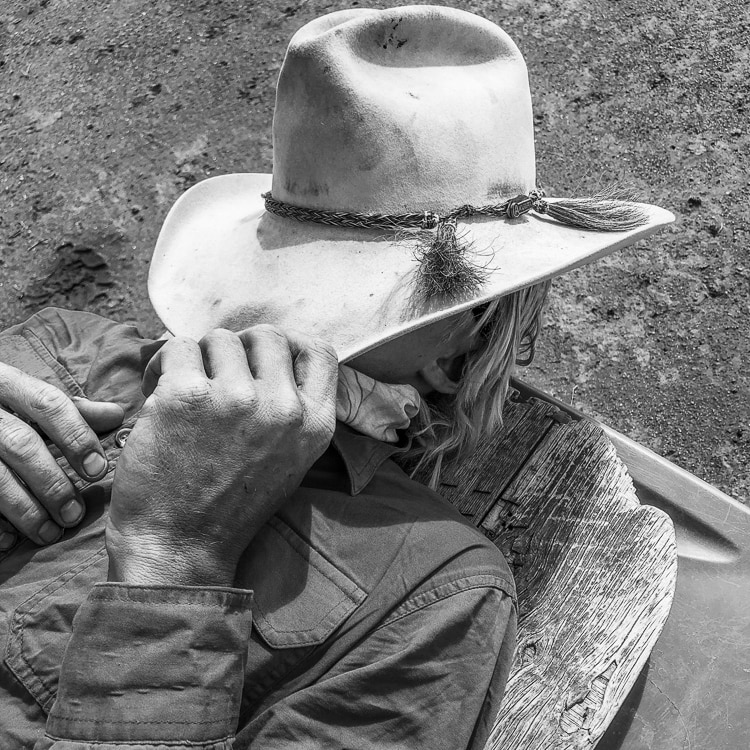 A hard-working western grazier takes a moment off, under his hat.