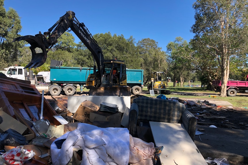 Rubbish being piled up by a digger.