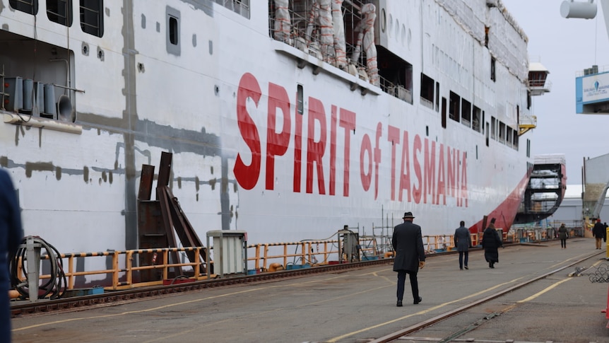 The side of a ship under construction with Spirit of Tasmanian in red text on a white background.