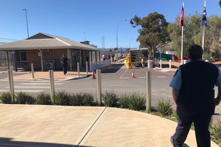 Firefighters and a fire truck at a prison gatehouse