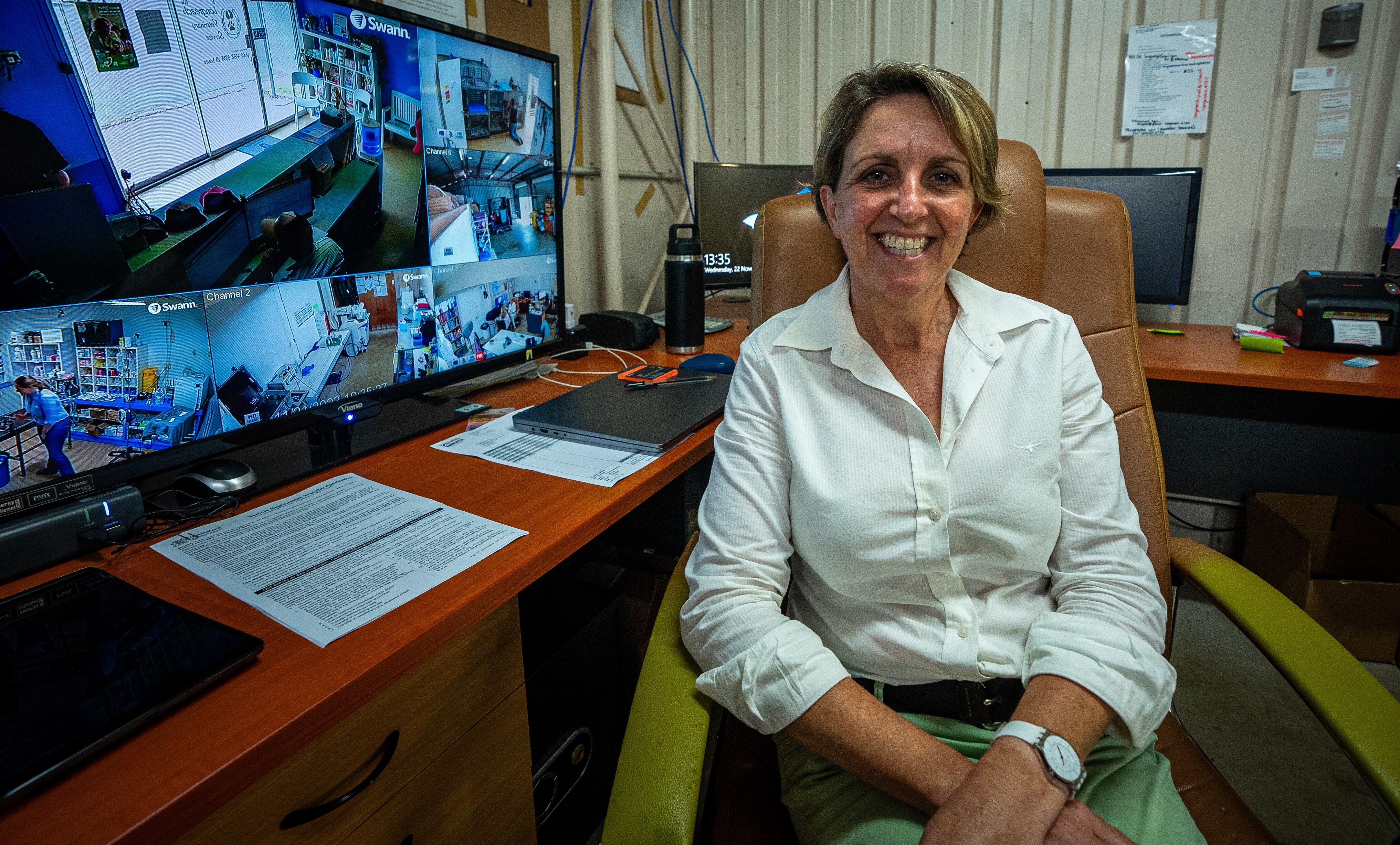 woman sitting typing behind desk