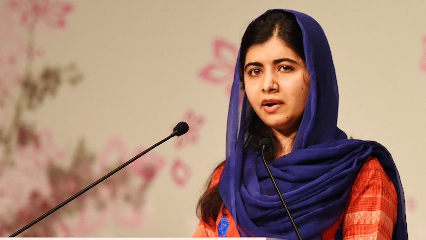 Malala Yousafzai speaks at a podium.