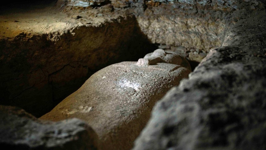 A limestone coffin buried in rock