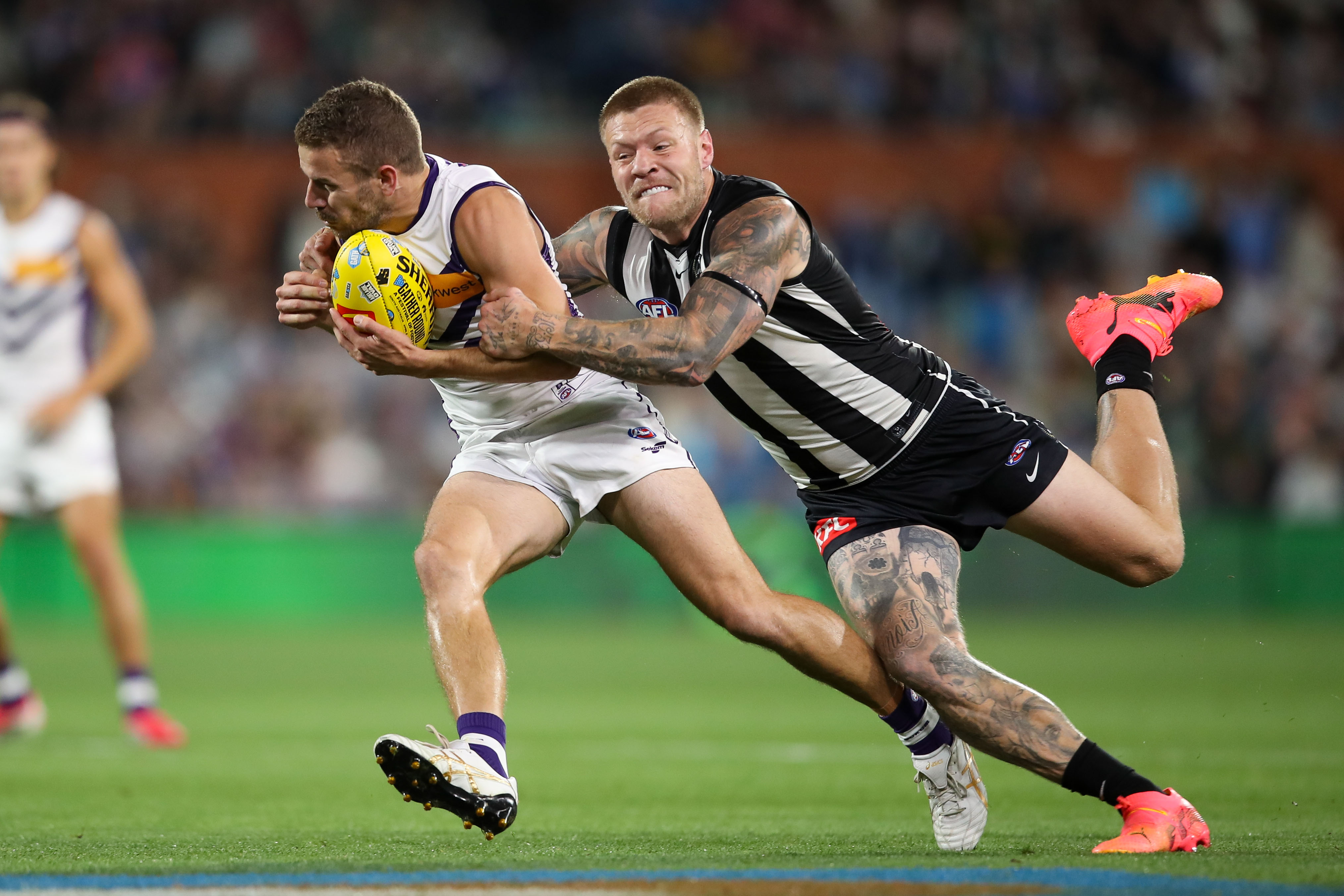 Sam Switkowski of the Dockers is tackled by Jordan De Goey of the Magpies.