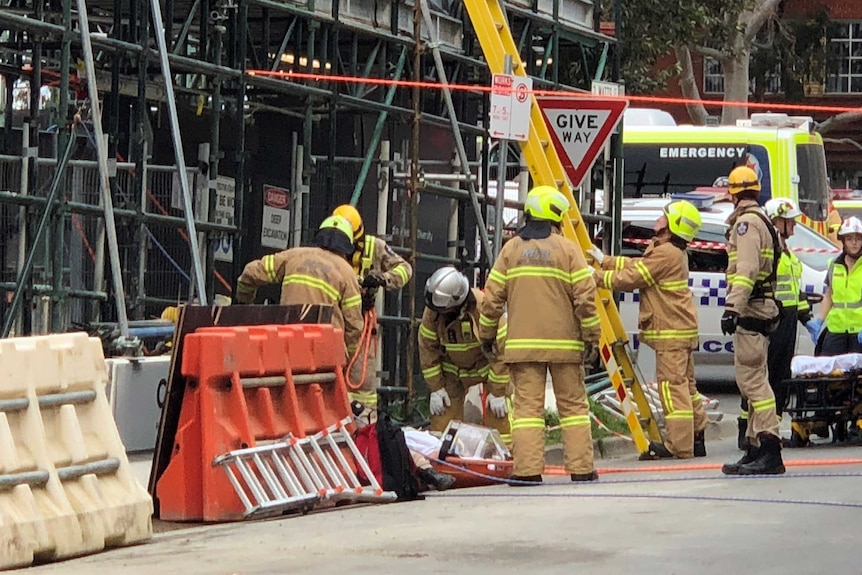 Emergency workers at the scene of a crane accident.