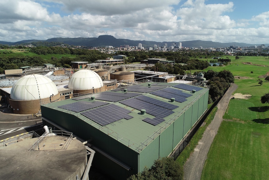Wollongong waste water treatment plant from a drone, with the escarpment and city in the background.