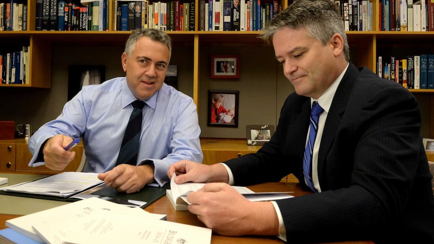 LtoR Treasurer Joe Hockey and Finance Minister Mathias Cormann check the budget papers.