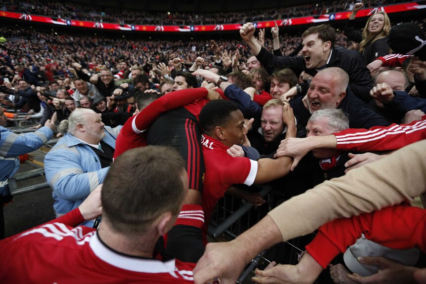 Anthony Martial celebrates with the fans at Wembley