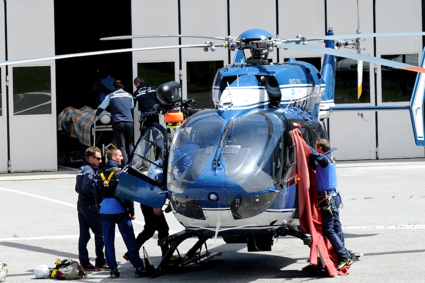 A French Gendarmerie team arrives in Chamonix with the body of victim killed in the avalanche.
