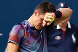 Bernard Tomic wipes sweat from his brow at US Open.