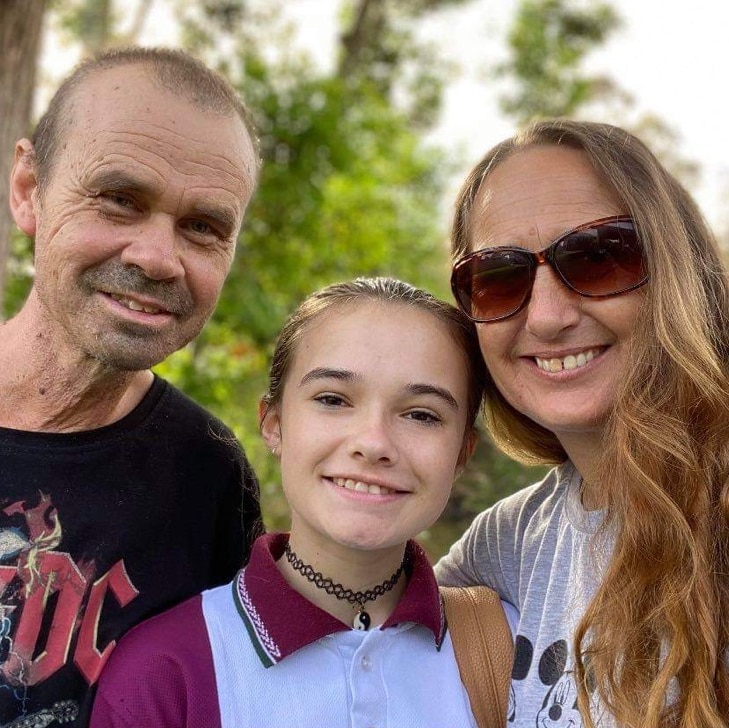 Three people smile at the camera.