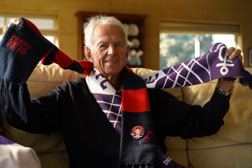 Ian Brayshaw man with football scarves around neck 