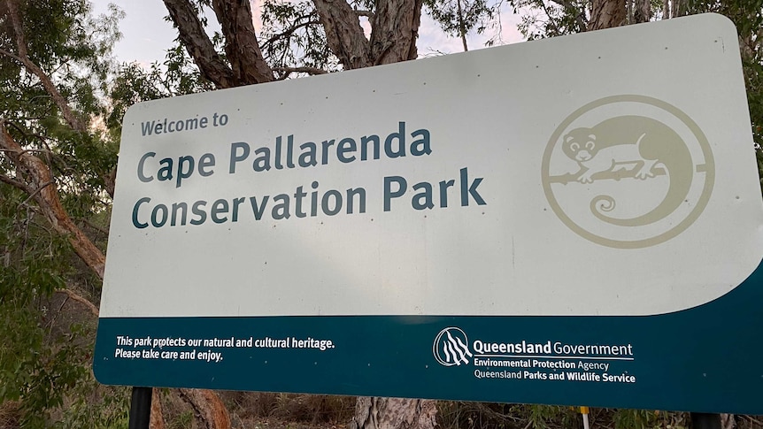Signage in front of trees. The sign reads 'Welcome to Cape Pallarenda Conservation Park'.