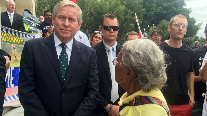 WA Premier Colin Barnett is approached by an Aboriginal woman at a rally held in Perth against the closure of Aboriginal communities.