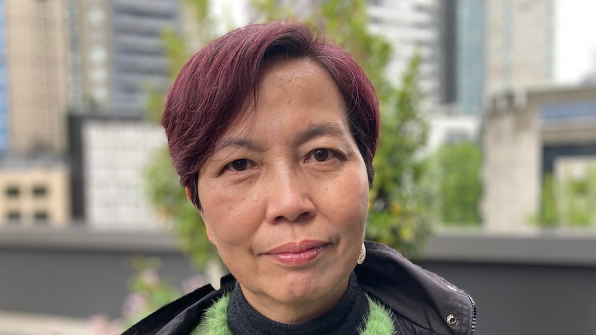 A profile photo of woman in a green jumper who is looking at the camera.