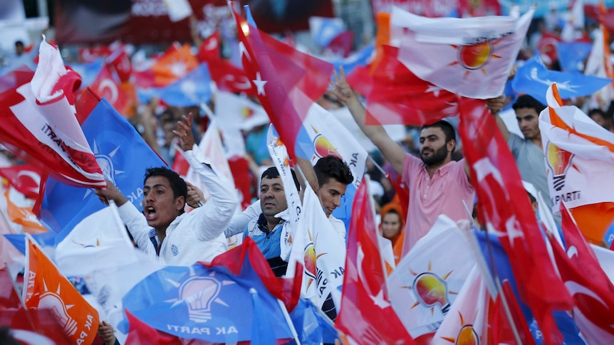 Supporters of ruling AK Party wave Turkish and party flags as they listen to Prime Minister Ahmet Davutoglu (not pictured) during an election rally for Turkey's June 7 parliamentary election, in Gaziantep, Turkey, June 5, 2015