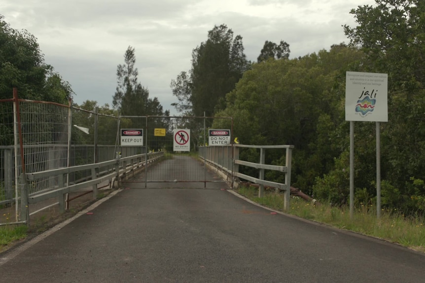 a face is set up at a bridge with signs indicating access is restricted