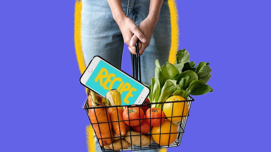 A woman holds a basket containing groceries and a smartphone designed to show ways to save time shopping