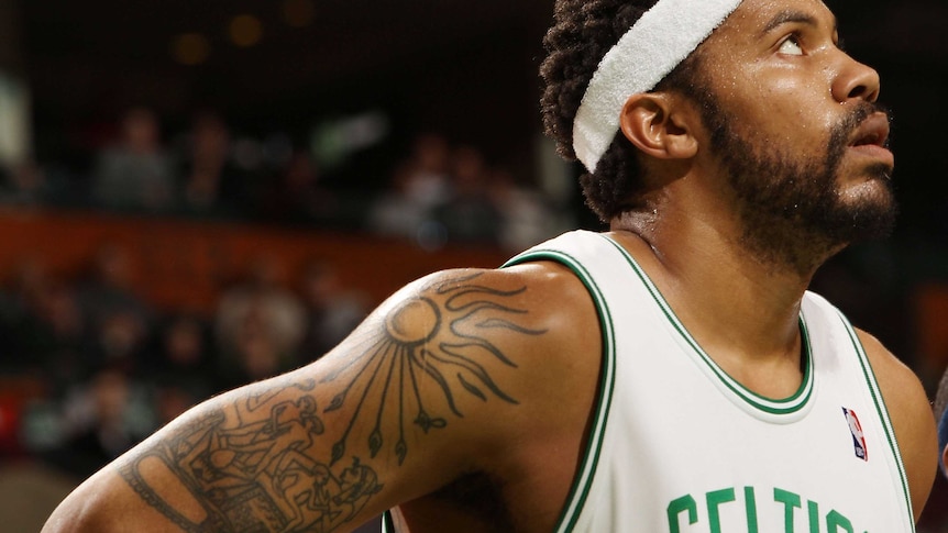 Rasheed Wallace's tattooed right arm is visible as he looks on during a game against the New Jersey Nets.