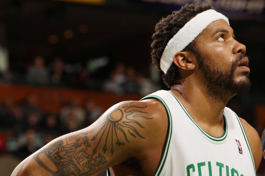 Rasheed Wallace's tattooed right arm is visible as he looks on during a game against the New Jersey Nets.