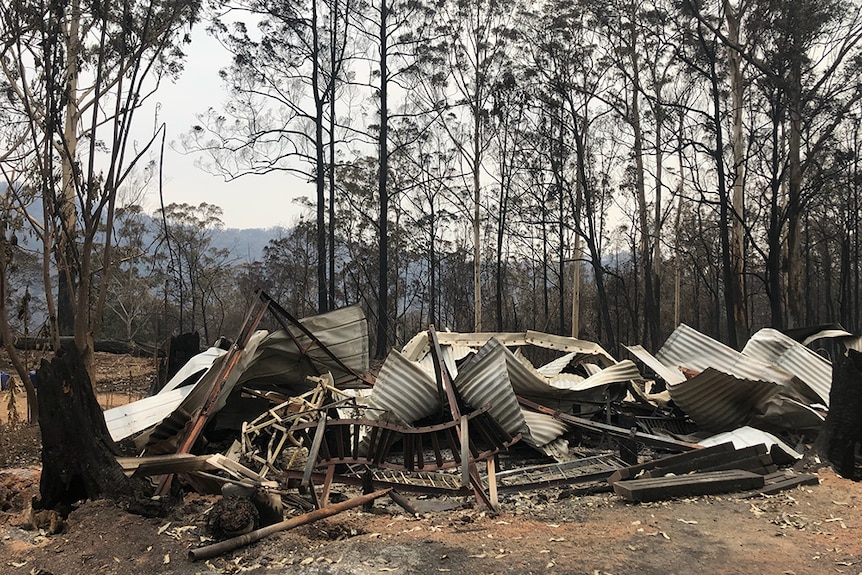 Twisted and burnt corrugated iron in the aftermath of a bushfire