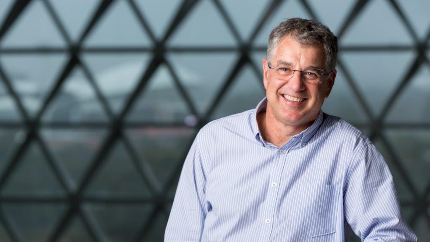 Professor Steve Wesselingh is executive director of SAHMRI. He stands in front of a window with triangle panels.