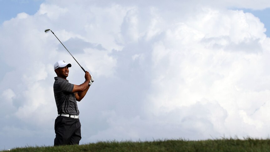 Still prowling ... Tiger Woods plays a shot on the 15th hole