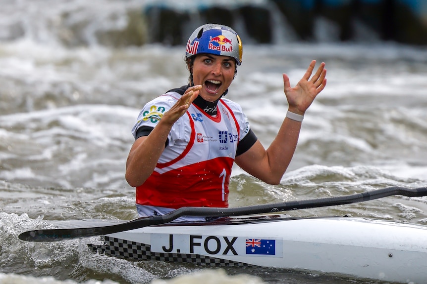 Kayaker Jessica Fox celebrates by clapping her hands, in the kayak, in the water and the end of the course