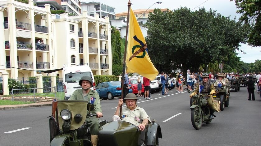 Veterans ride in historic war vehicles at Townsville's Anzac Day parade.