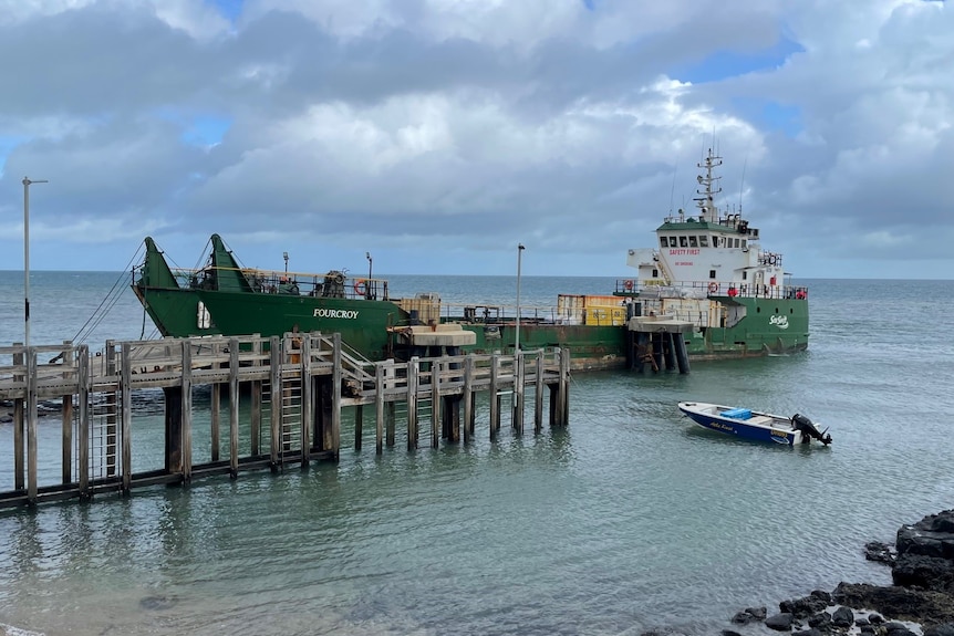 A barge is docked at a jetty