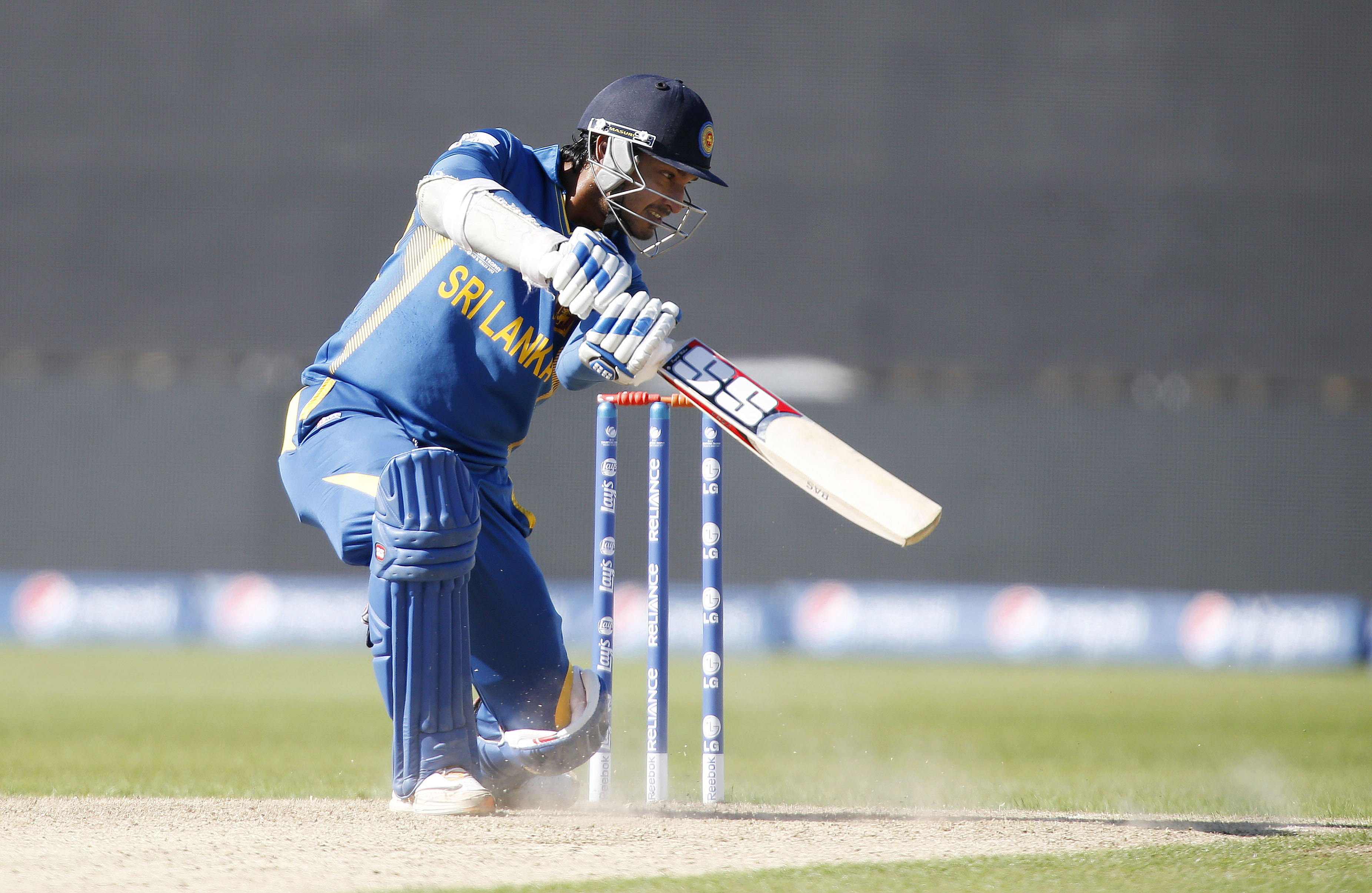 Cricket player swings the bat