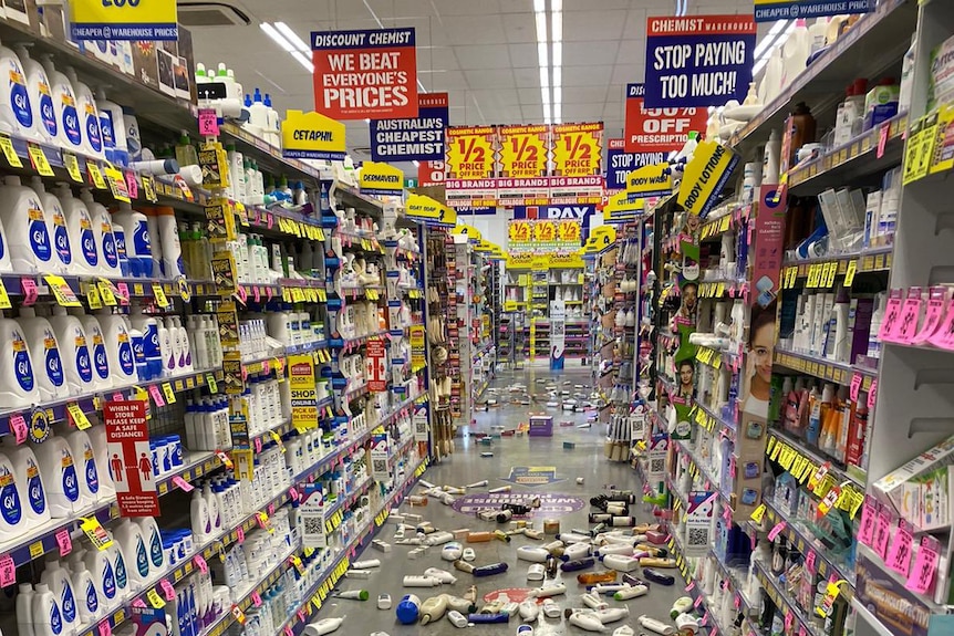 A chemist aisle strewn with products 