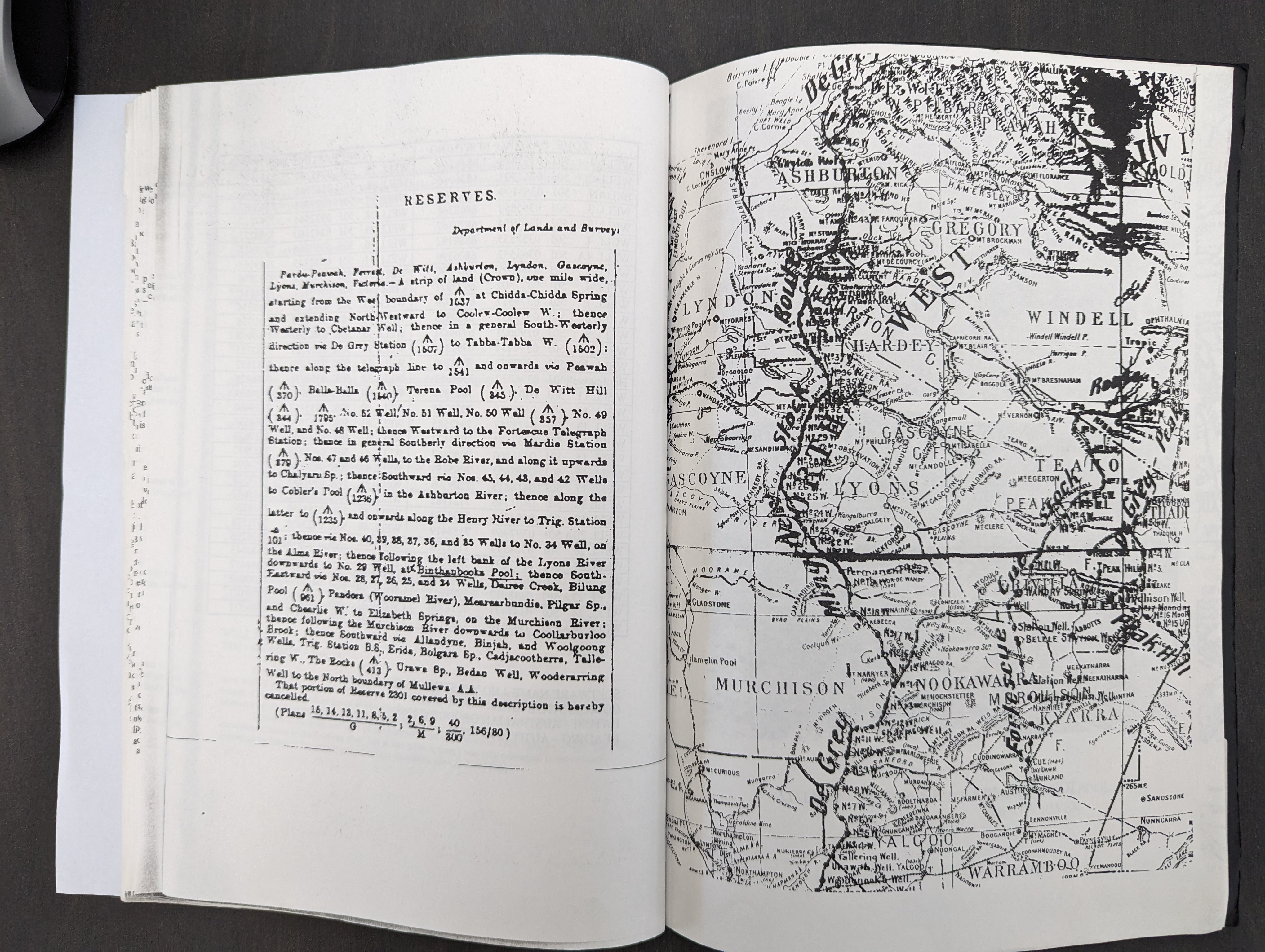 A black an white map of stock routes is visible on the page of an open book. 