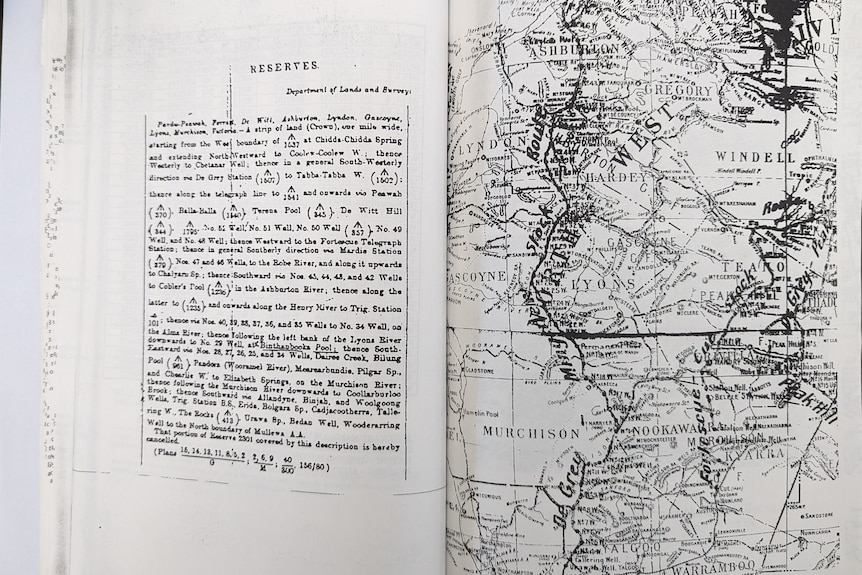 A black an white map of stock routes is visible on the page of an open book. 
