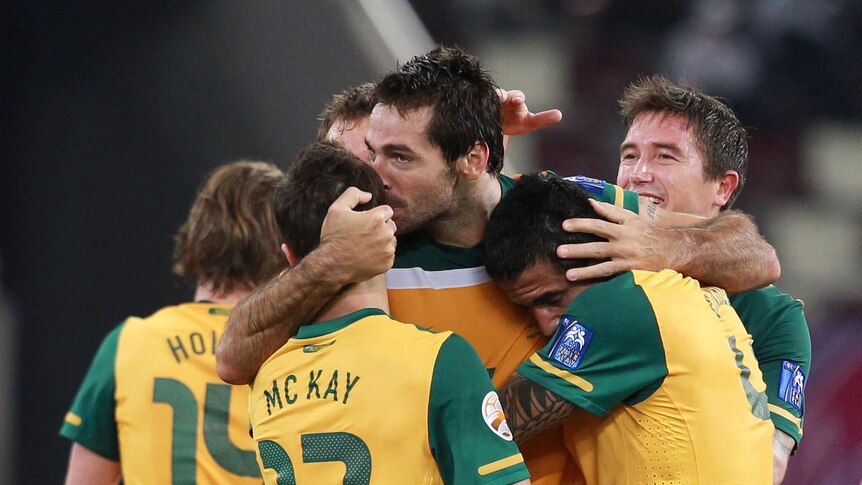 Rout: Sasa Ognenovski puts Australia two goals to the good in a six-goal humbling of Uzbekistan.