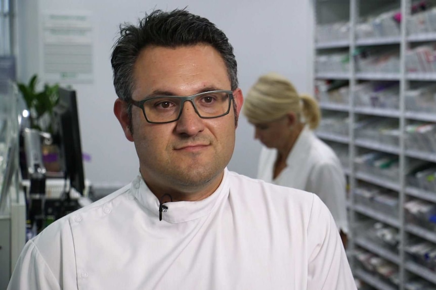 Pharmacist Anthony Tassone standing at a pharmacy counter