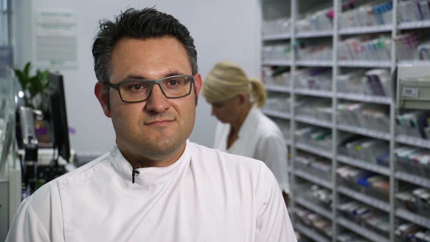 Pharmacist Anthony Tassone standing at a pharmacy counter