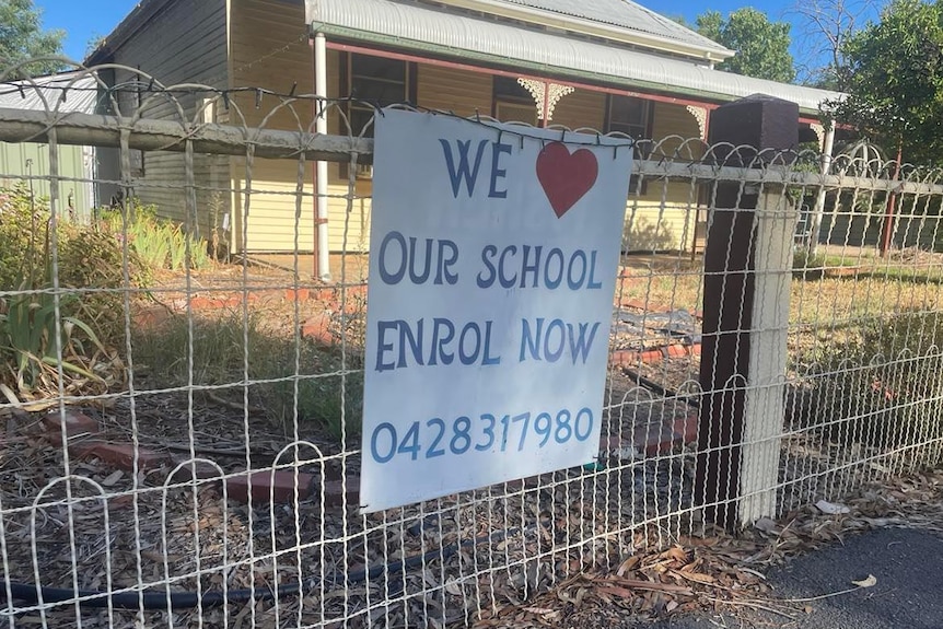 sign on fence that says we love our school